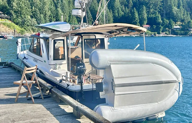 Denial Yacht Photos Pics Cutwater C-28 boat docked by a lake, surrounded by lush forest, 2012 model.