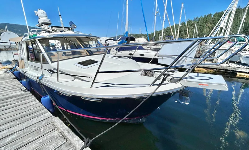 Denial Yacht Photos Pics 2012 Cutwater C-28 boat docked at marina, surrounded by sailboats and clear blue sky.