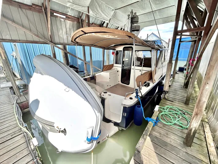 Denial Yacht Photos Pics 2012 Cutwater C-28 boat docked in covered marina with outboard motor.
