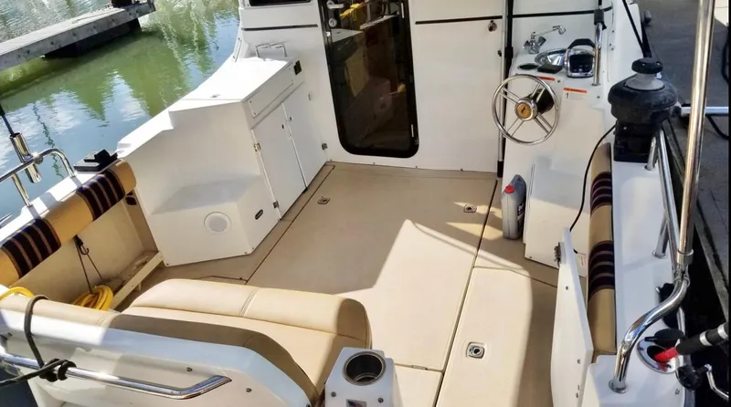 Denial Yacht Photos Pics 2012 Cutwater C-28 boat interior with seating, steering wheel, and open deck space.