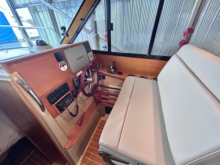 Denial Yacht Photos Pics Interior of 2012 Cutwater C-28 boat with steering wheel and seating.