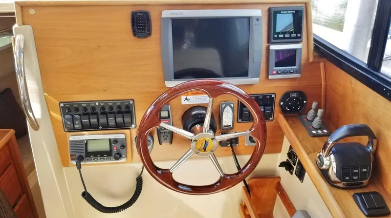Denial Yacht Photos Pics Control panel of a 2012 Cutwater C-28 boat with steering wheel and navigation instruments.