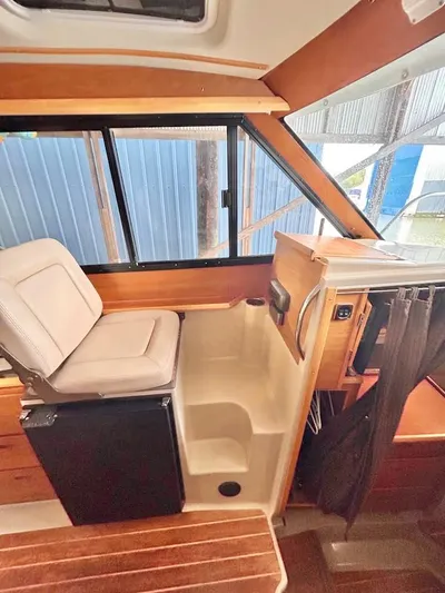 Denial Yacht Photos Pics Interior of a 2012 Cutwater C-28 boat, featuring seating and window view.