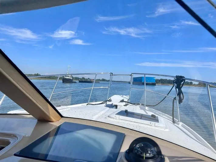 Denial Yacht Photos Pics 2012 Cutwater C-28 boat navigating calm waters under a clear blue sky.