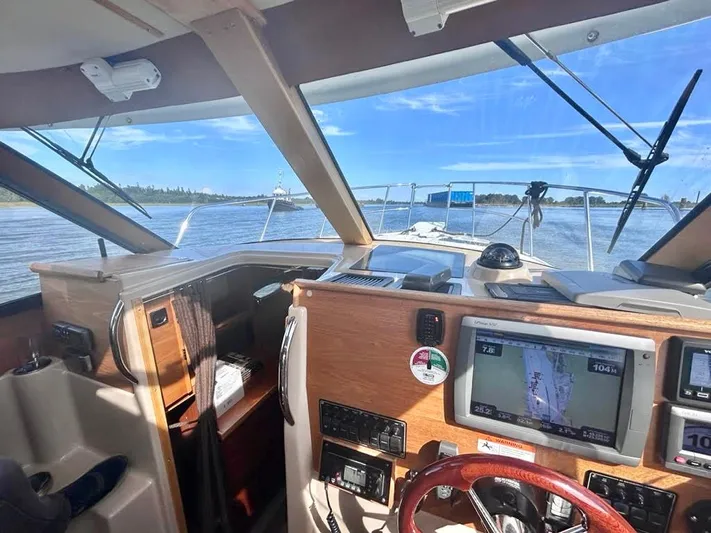 Denial Yacht Photos Pics Interior view of 2012 Cutwater C-28 boat cockpit with navigation screens and steering wheel.