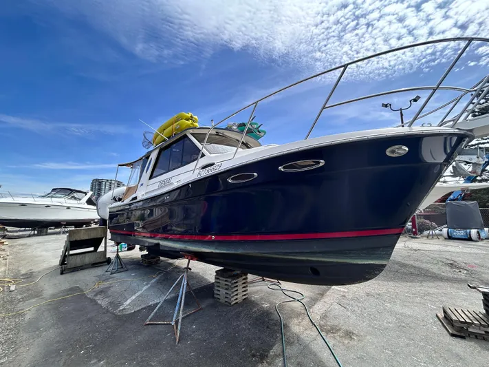 Denial Yacht Photos Pics 2012 Cutwater C-28 boat on dry dock under a clear blue sky.