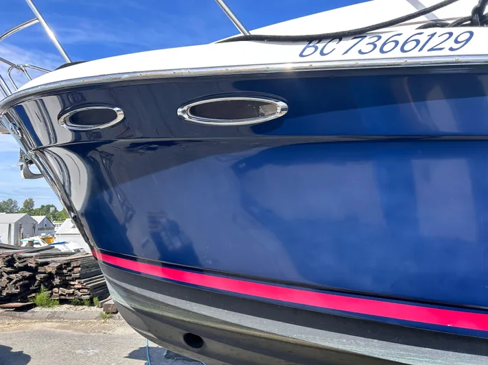 Denial Yacht Photos Pics 2012 Cutwater C-28 boat with blue hull and red stripe, docked outdoors.