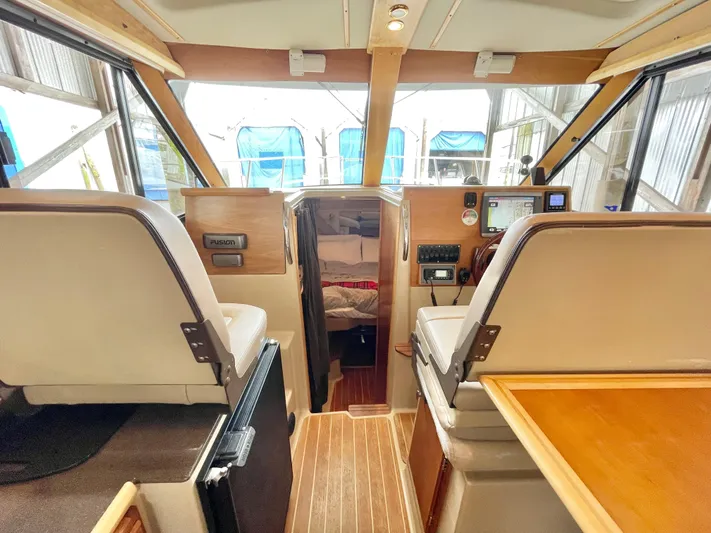 Denial Yacht Photos Pics Interior of 2012 Cutwater C-28 boat with helm, seating, and cabin view.