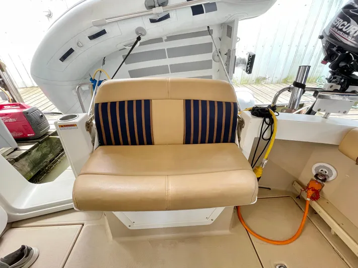 Denial Yacht Photos Pics 2012 Cutwater C-28 boat seat with tan and blue striped upholstery.