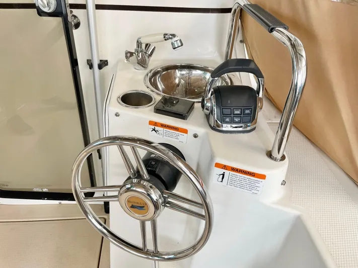 Denial Yacht Photos Pics Steering wheel and controls of a 2012 Cutwater C-28 boat, featuring a sink and faucet.