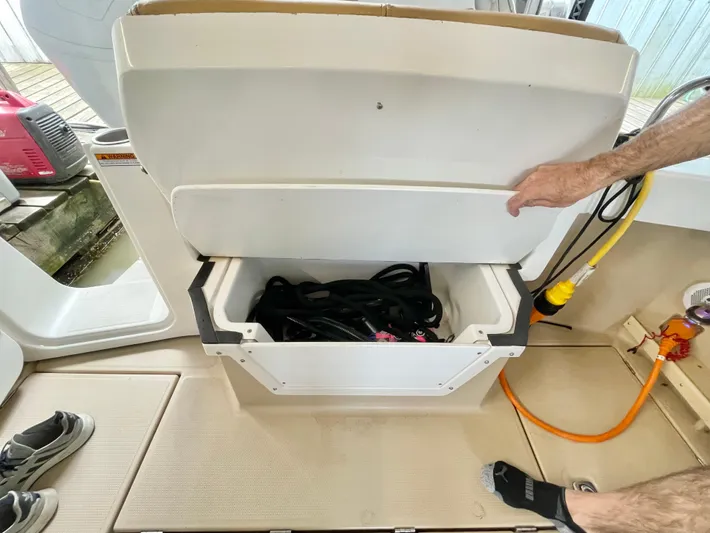 Denial Yacht Photos Pics Open storage compartment on 2012 Cutwater C-28 boat deck with cables inside.