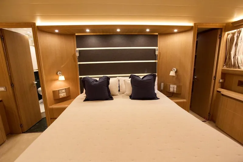 Pobedy I Yacht Photos Pics Luxurious bedroom interior of 2004 Maiora 26.5 yacht with elegant lighting and decor.