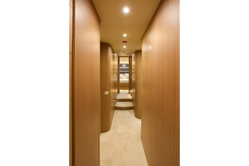 Pobedy I Yacht Photos Pics Luxurious hallway interior of 2004 Maiora 26.5 yacht with wooden paneling and soft lighting.