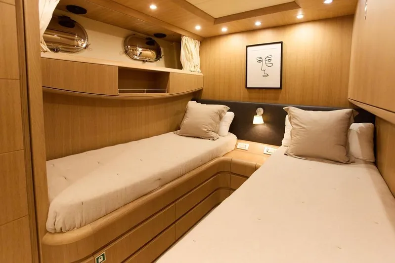 Pobedy I Yacht Photos Pics Luxurious 2004 Maiora 26.5 yacht cabin with twin beds and modern decor.