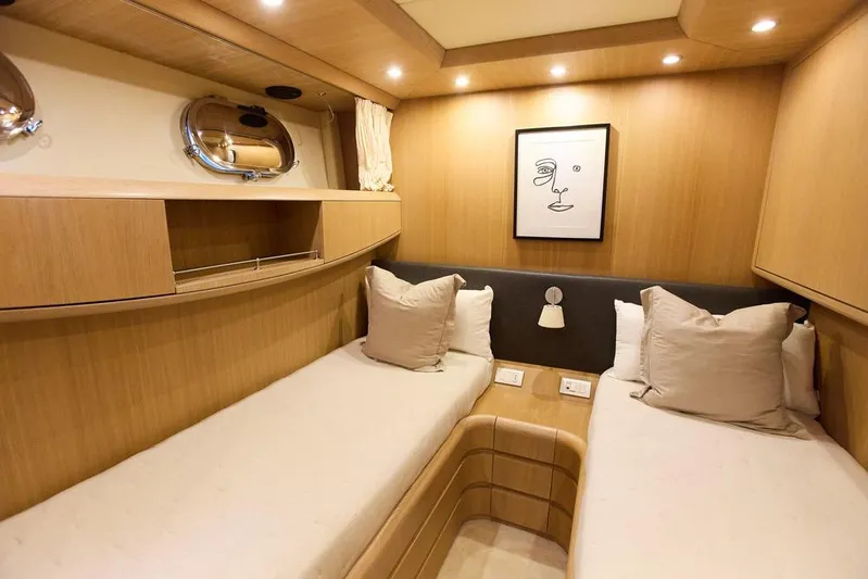 Pobedy I Yacht Photos Pics Luxurious 2004 Maiora 26.5 yacht cabin with twin beds and modern decor.