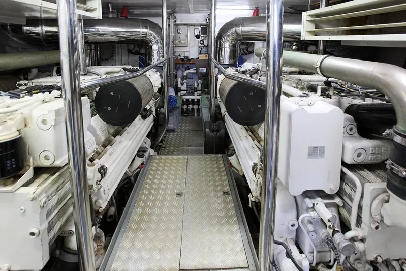 Pobedy I Yacht Photos Pics Engine room of 2004 Maiora 26.5 yacht, featuring dual engines and metallic piping.