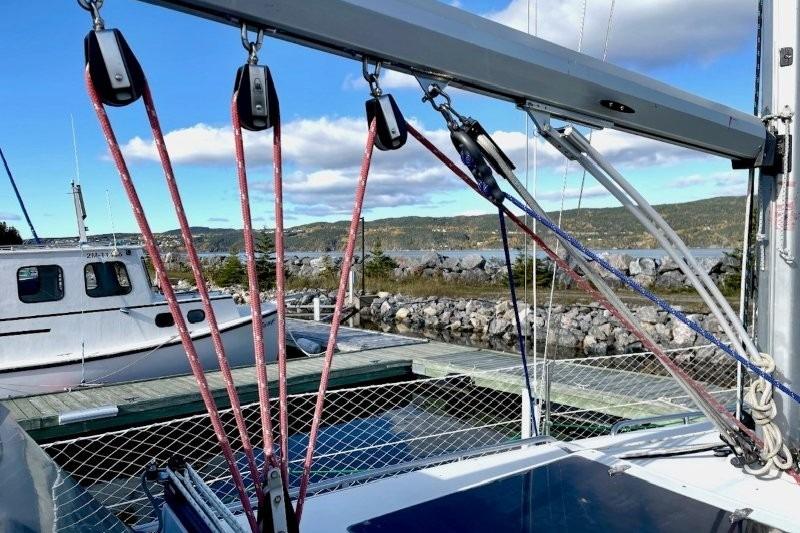 Sailboat rigging on a 1990 CS 34, docked with scenic waterfront view.