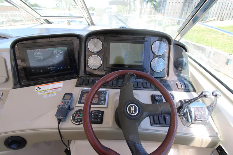 Rowdy Rio Yacht Photos Pics 2008 Sea Ray 44 Sundancer helm with navigation screens and controls.
