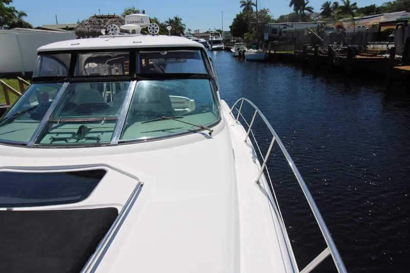 Rowdy Rio Yacht Photos Pics 2008 Sea Ray 44 Sundancer yacht on a calm canal with clear skies.