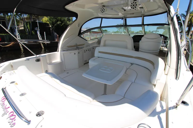Rowdy Rio Yacht Photos Pics 2008 Sea Ray 44 Sundancer yacht with spacious white seating and table in the cockpit area.