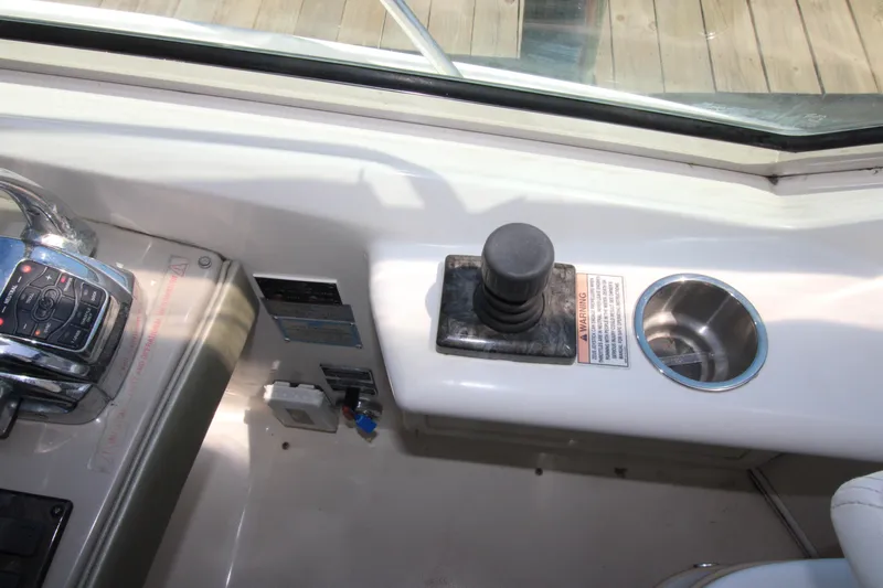 Rowdy Rio Yacht Photos Pics Control panel of a 2008 Sea Ray 44 Sundancer yacht with joystick and cup holder.