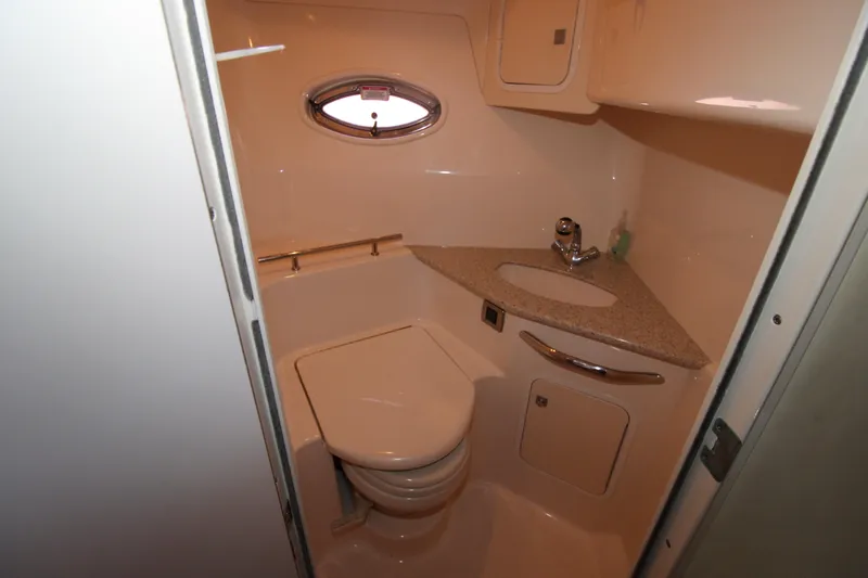 Rowdy Rio Yacht Photos Pics 2008 Sea Ray 44 Sundancer bathroom with compact design, porthole, and modern fixtures.