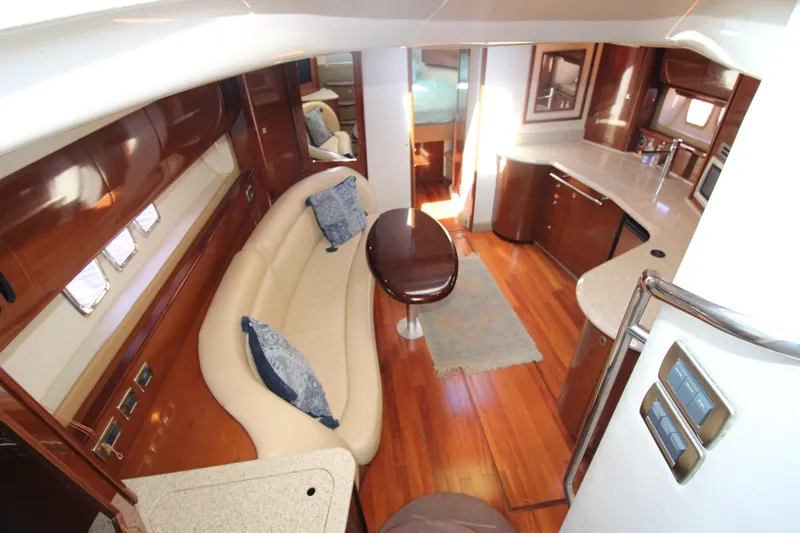 Rowdy Rio Yacht Photos Pics Luxurious interior of 2008 Sea Ray 44 Sundancer yacht with elegant seating and kitchen area.