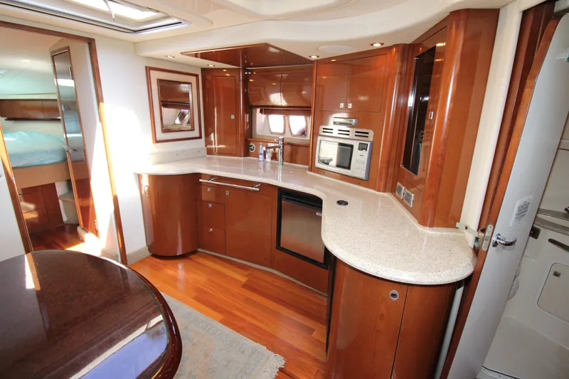 Rowdy Rio Yacht Photos Pics Luxurious 2008 Sea Ray 44 Sundancer yacht interior with modern kitchen and wood finishes.