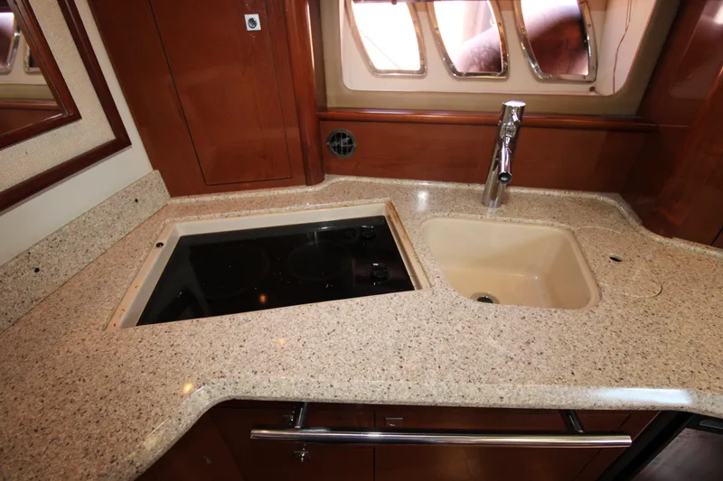 Rowdy Rio Yacht Photos Pics Luxurious kitchen area in 2008 Sea Ray 44 Sundancer yacht with sink and stovetop.