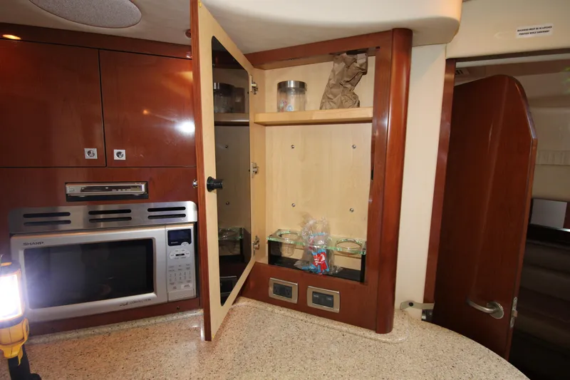 Rowdy Rio Yacht Photos Pics 2008 Sea Ray 44 Sundancer kitchen with open cabinet and modern appliances.
