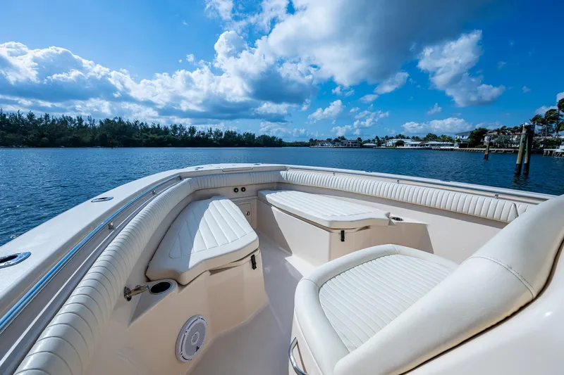  Yacht Photos Pics 2012 Grady-White 336 boat interior with cushioned seating, overlooking serene water and blue sky.