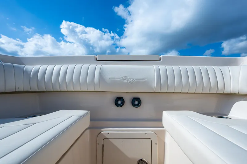  Yacht Photos Pics Grady-White 336 boat interior, 2012 model, featuring white cushioned seating under a blue sky.