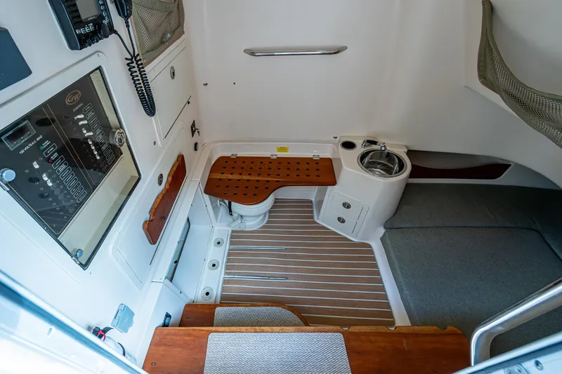  Yacht Photos Pics 2012 Grady-White 336 boat interior with wooden flooring and control panel.