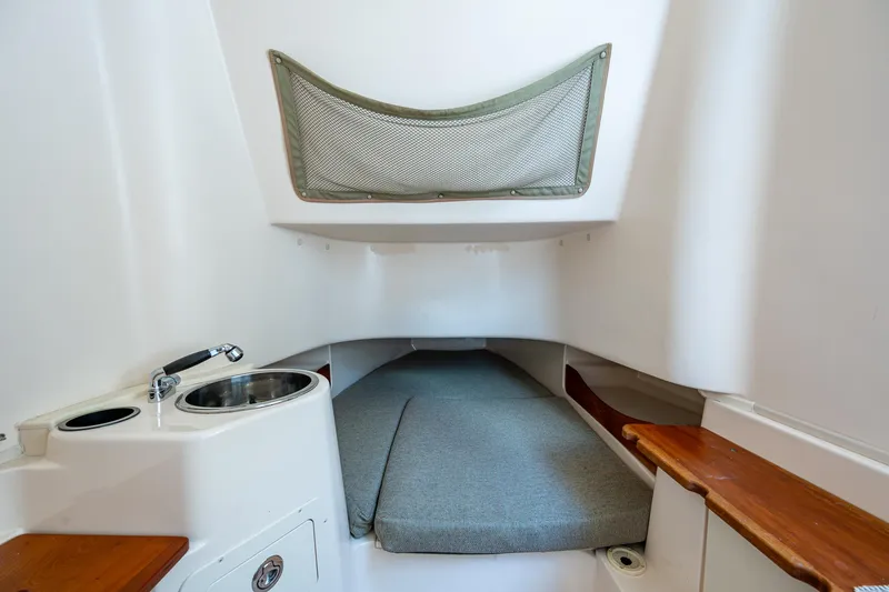  Yacht Photos Pics 2012 Grady-White 336 cabin interior with sink, bed, and storage net.