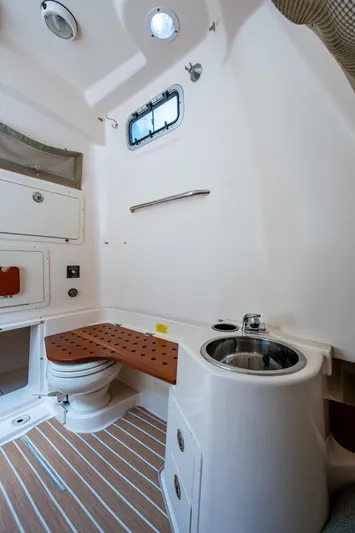  Yacht Photos Pics 2012 Grady-White 336 boat interior with compact bathroom, featuring a toilet and sink.