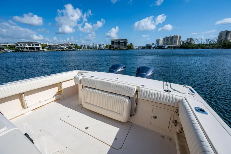  Yacht Photos Pics 2012 Grady-White 336 boat deck with twin engines, overlooking a scenic waterfront.
