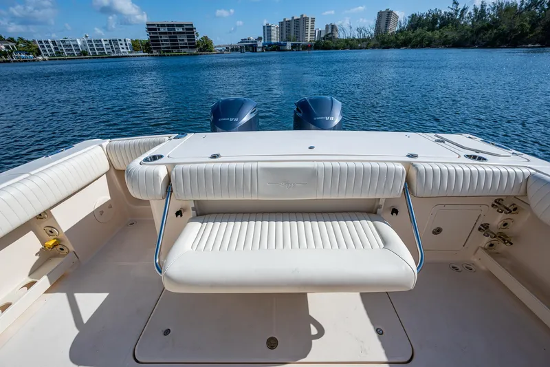  Yacht Photos Pics 2012 Grady-White 336 boat with seating, overlooking calm waters and distant buildings.
