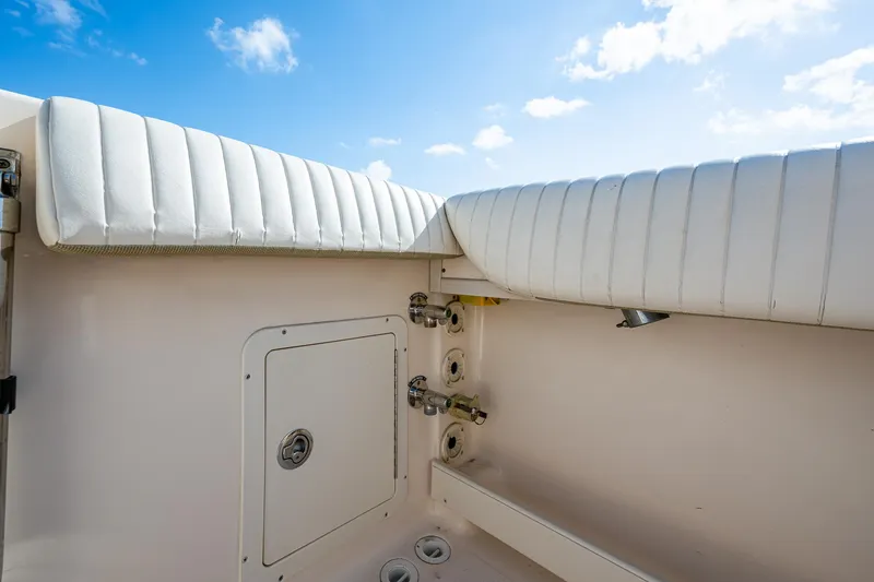  Yacht Photos Pics Grady-White 336 boat interior, 2012 model, featuring white cushioned seating and storage compartment.