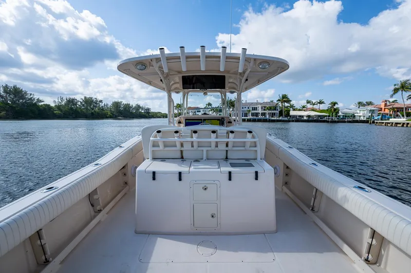 Yacht Photos Pics 2012 Grady-White 336 boat on calm water, clear sky, and waterfront homes in the background.
