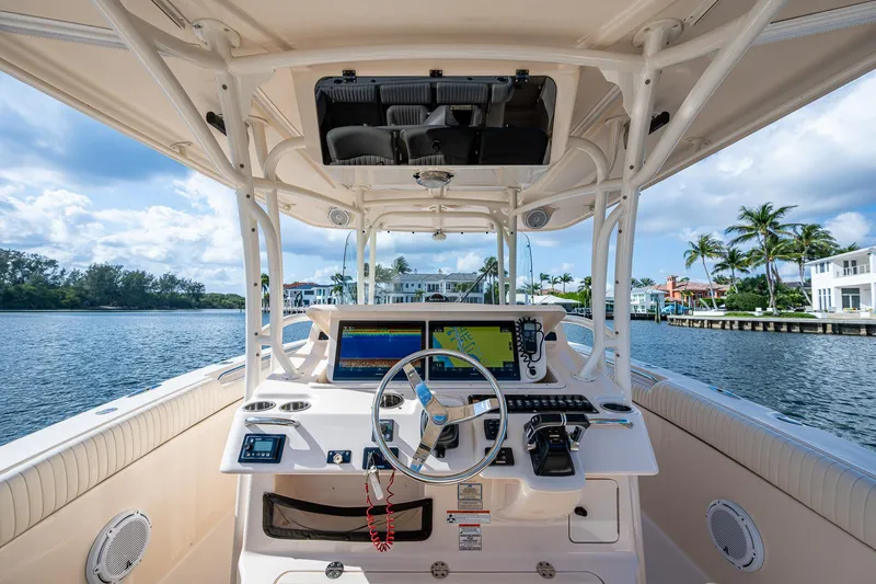  Yacht Photos Pics 2012 Grady-White 336 boat helm with navigation screens, steering wheel, and waterfront view.