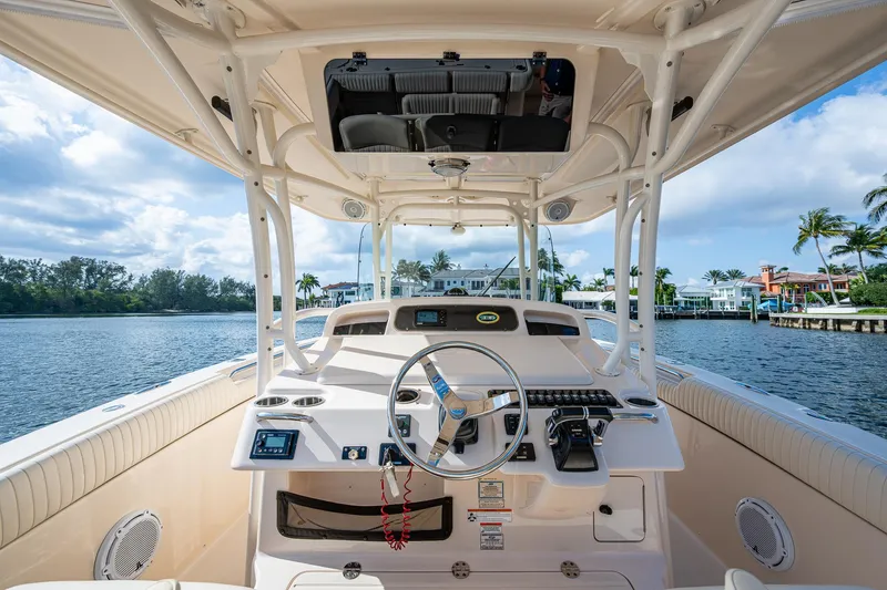  Yacht Photos Pics 2012 Grady-White 336 boat helm with steering wheel, controls, and waterfront view.
