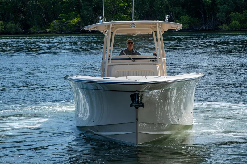  Yacht Photos Pics 2012 Grady-White 336 boat cruising on a calm river with lush greenery.