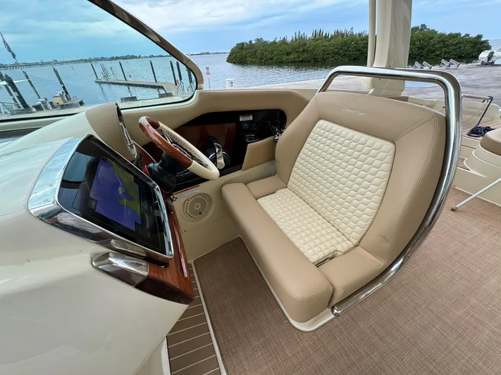  Yacht Photos Pics 2021 Chris-Craft Launch 31 GT helm seat with beige upholstery and navigation screen.
