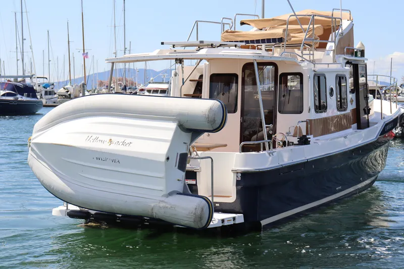 Yellow Jacket Yacht Photos Pics 2020 Ranger Tugs R-31 CB boat with dinghy, docked in a marina.