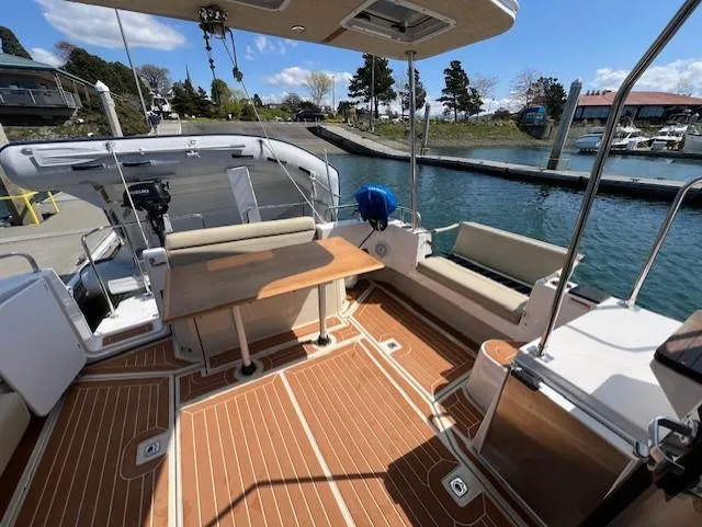 Yellow Jacket Yacht Photos Pics 2020 Ranger Tugs R-31 CB boat deck with seating and table, docked by the water.