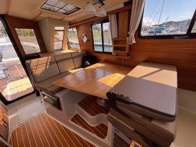 Yellow Jacket Yacht Photos Pics Interior of 2020 Ranger Tugs R-31 CB with wood accents and spacious seating area.