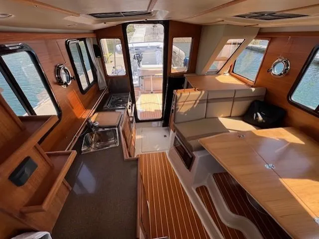 Yellow Jacket Yacht Photos Pics Interior of 2020 Ranger Tugs R-31 CB, featuring wood finishes and spacious seating.