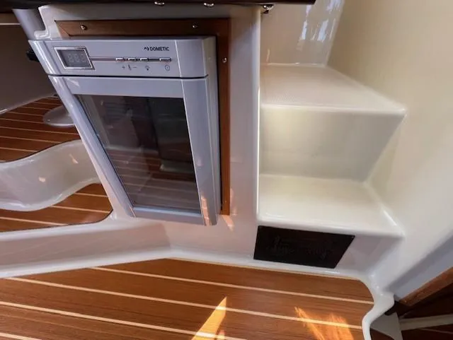 Yellow Jacket Yacht Photos Pics 2020 Ranger Tugs R-31 CB interior with Dometic fridge and wooden flooring.