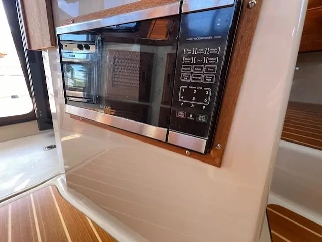 Yellow Jacket Yacht Photos Pics 2020 Ranger Tugs R-31 CB interior microwave with control panel and wood accents.