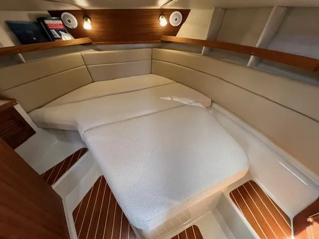 Yellow Jacket Yacht Photos Pics 2020 Ranger Tugs R-31 CB cabin interior with cozy bed and wooden accents.